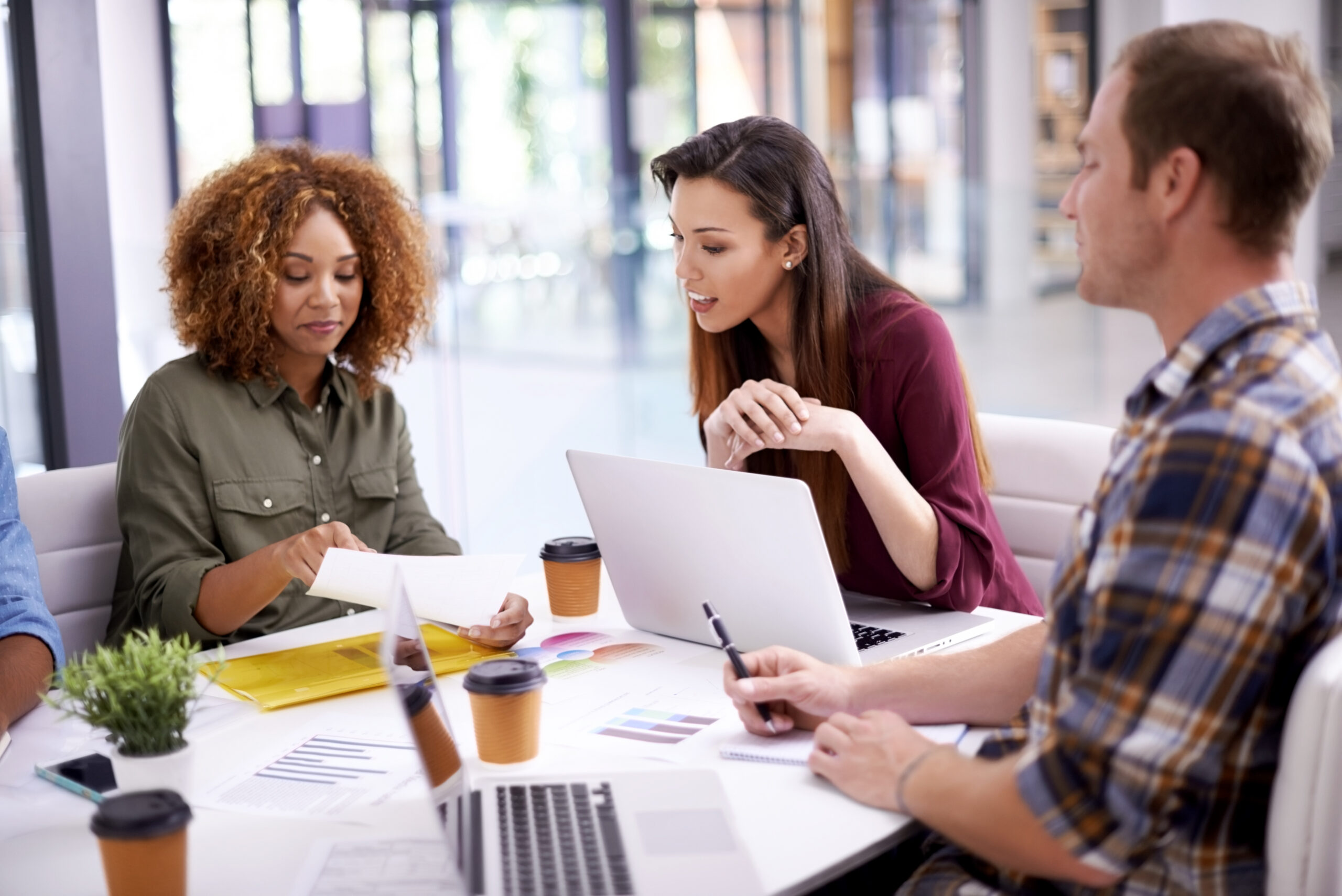 Office, brainstorming and business people in meeting, planning and cooperation with laptop, documents and speaking. Design agency, staff or group with technology, paperwork and collaboration for idea Office, brainstorming and business people in meeting, planning and cooperation with laptop, documents and speaking. Design agency, staff or group with technology, paperwork and collaboration for idea.